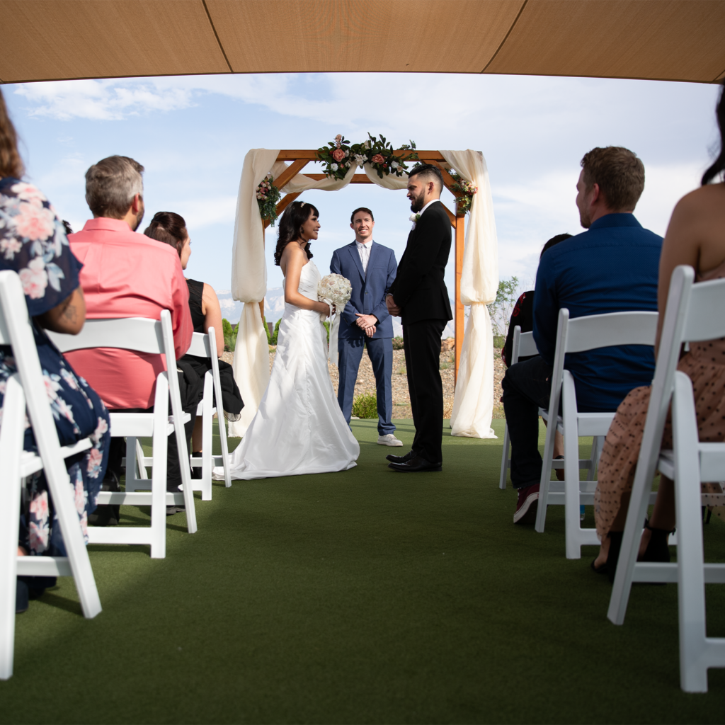 Couple getting married on a green grass field